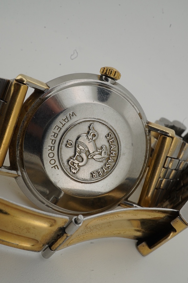 A gentleman's 1960's? steel and gold plated Omega Seamaster De Ville Automatic wrist watch, with baton numerals and date aperture, case diameter 35mm, on an associated gold plated steel bracelet(worn), no box or papers.
